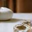 A serene ceramic essential oil diffuser next to a glass of water, symbolizing sleep optimization